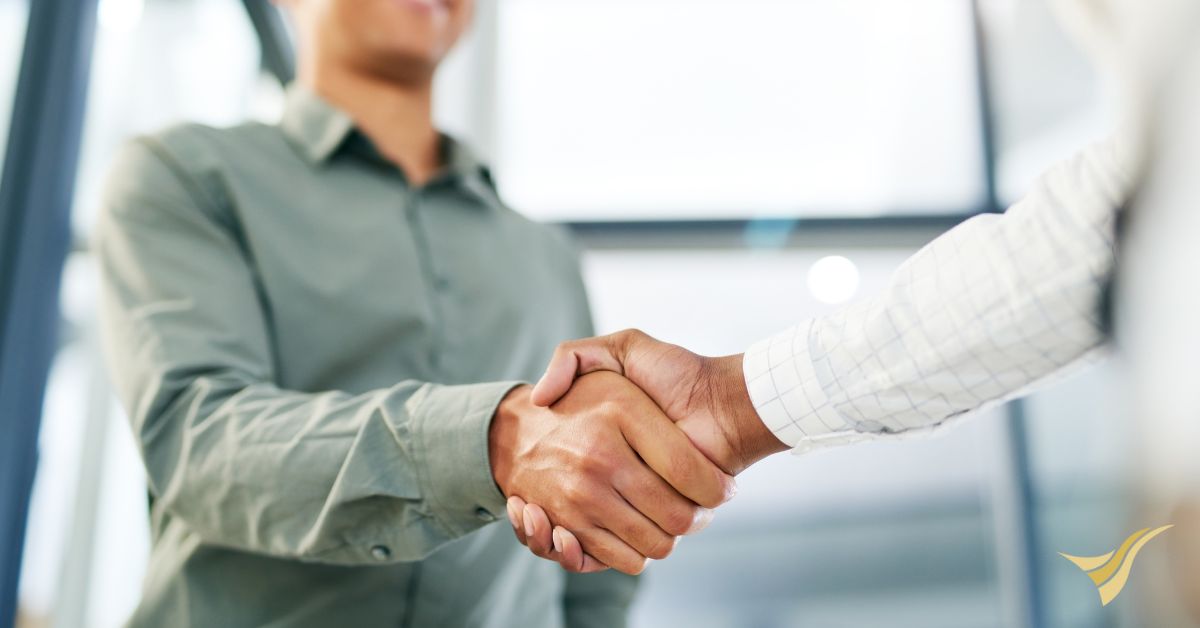 Professionals shake hands to celebrate new job