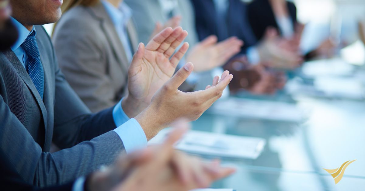 Business professionals in clapping during meeting