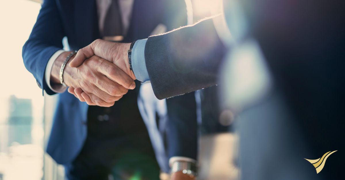 Business men shaking hands to signify new partnership